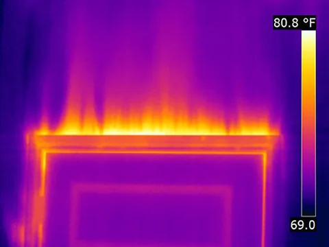 Thermal image showing heat escaping around a window or door frame